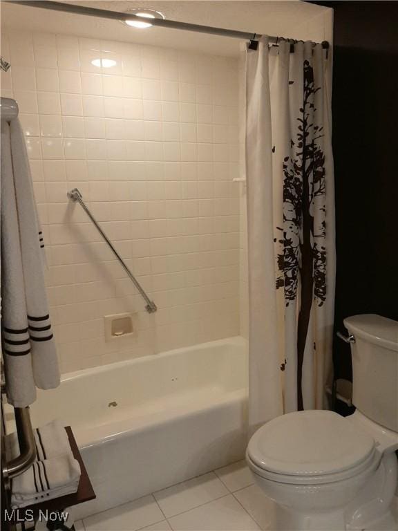 full bath with shower / bath combo, tile patterned flooring, and toilet