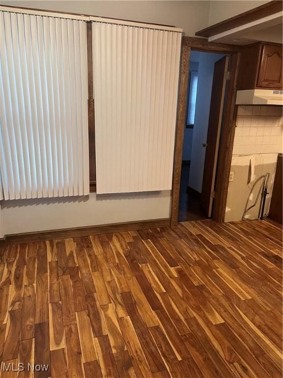 unfurnished room with wood finished floors