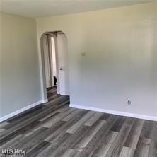 181 E Judson Ave, Youngstown, OH 44507 - spare room featuring arched walkways, baseboards, and wood finished floors