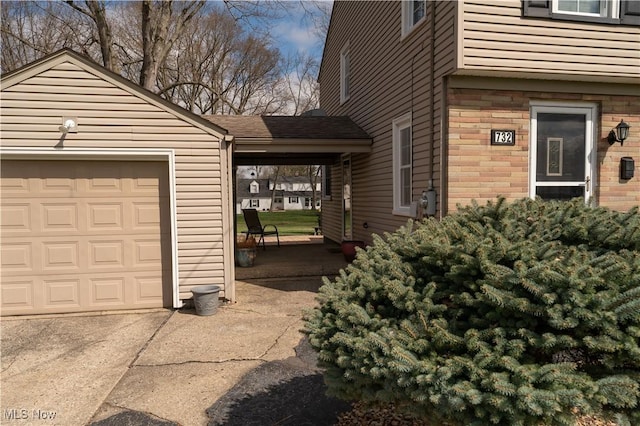 732 Wildwood Dr, Boardman, OH 44512 - view of side of property with an attached garage, a shingled roof, and driveway