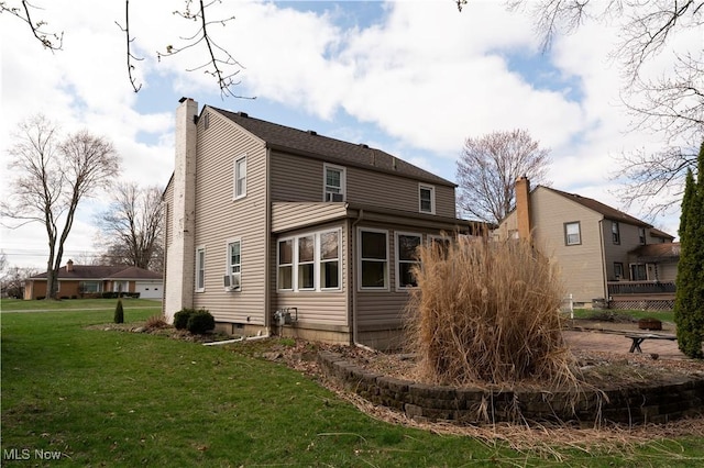 732 Wildwood Dr, Boardman, OH 44512 - back of house featuring cooling unit, a lawn, and a chimney