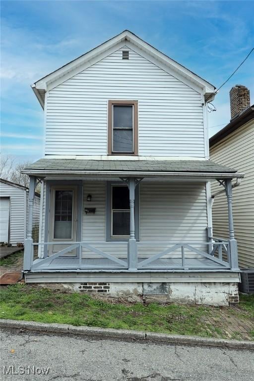 view of front of house featuring cooling unit and covered porch