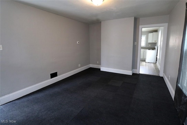 spare room featuring baseboards