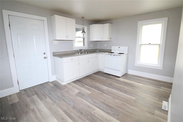 kitchen featuring baseboards, light countertops, white cabinetry, light wood finished floors, and white electric range oven