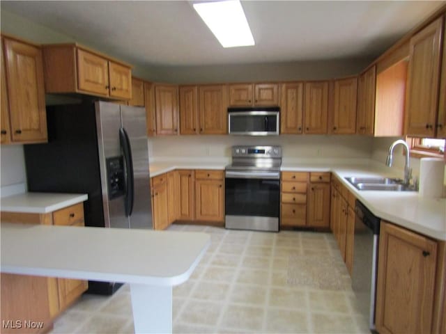 230 Bryden Rd, Weirton, WV 26062 - kitchen with light countertops, brown cabinets, appliances with stainless steel finishes, and a sink
