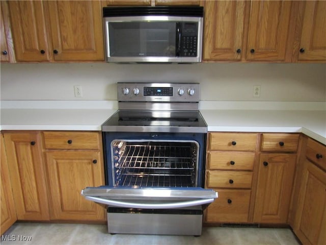 230 Bryden Rd, Weirton, WV 26062 - kitchen featuring stainless steel appliances, brown cabinets, and light countertops