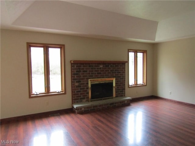 230 Bryden Rd, Weirton, WV 26062 - unfurnished living room featuring a raised ceiling, a fireplace, and dark wood-style floors