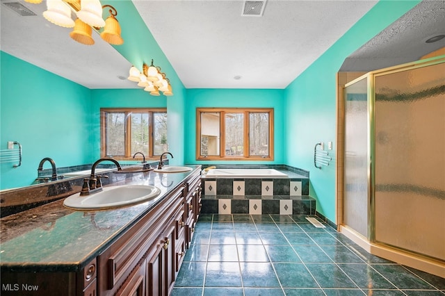 bathroom with a sink, visible vents, and a shower stall