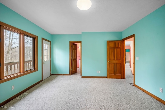unfurnished bedroom with baseboards, visible vents, and carpet floors