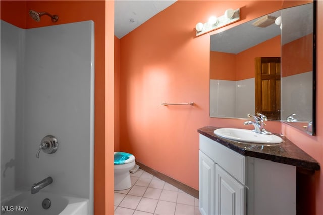 full bath with baseboards, toilet, vanity, tile patterned floors, and bathing tub / shower combination