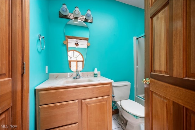 bathroom featuring tile patterned floors, toilet, vanity, and shower / bath combination with glass door