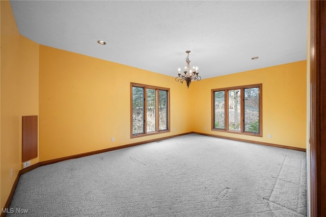 unfurnished room featuring a chandelier, baseboards, carpet, and recessed lighting