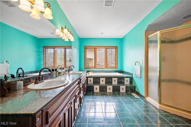 bathroom with a sink, visible vents, and tile patterned flooring