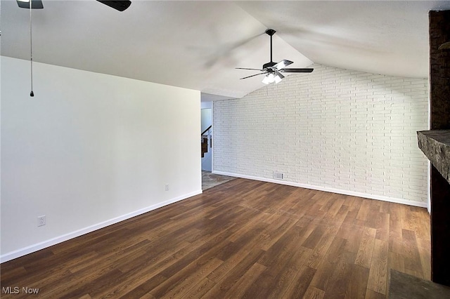 unfurnished living room with wood finished floors, brick wall, baseboards, and ceiling fan