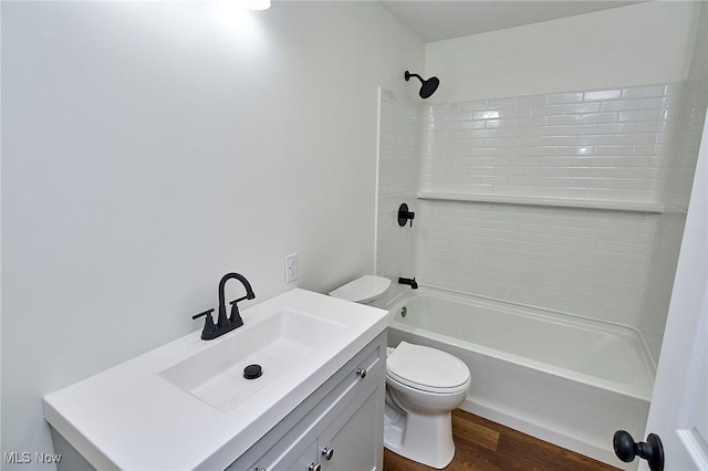 full bathroom with toilet, vanity, wood finished floors, and tub / shower combination