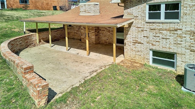 view of yard featuring central air condition unit, a carport, and a patio