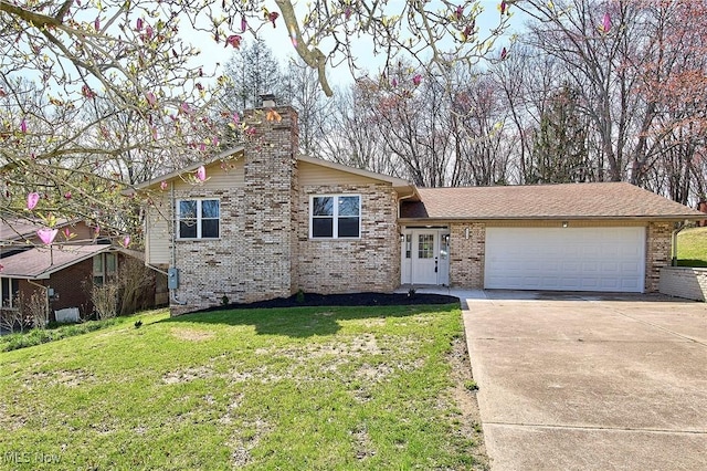 view of front facade with a chimney, a front lawn, driveway, an attached garage, and brick siding