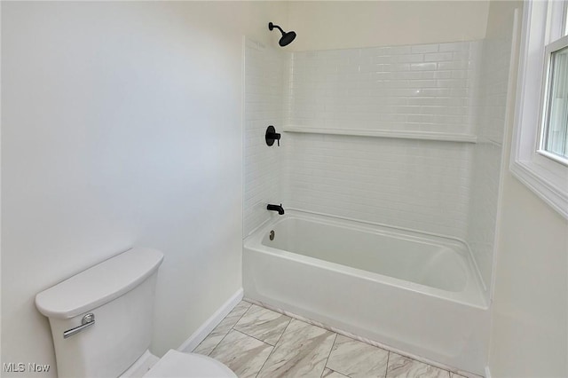 bathroom with shower / bath combination, toilet, baseboards, and marble finish floor