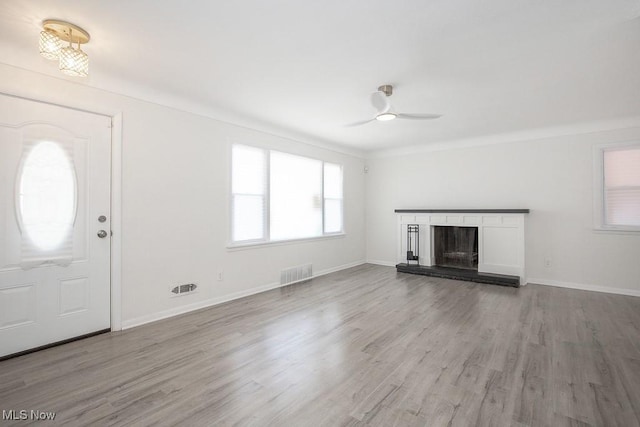 unfurnished living room featuring visible vents, ceiling fan, wood finished floors, and baseboards
