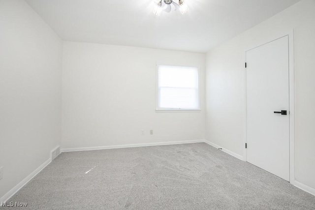 unfurnished bedroom with visible vents, baseboards, and carpet