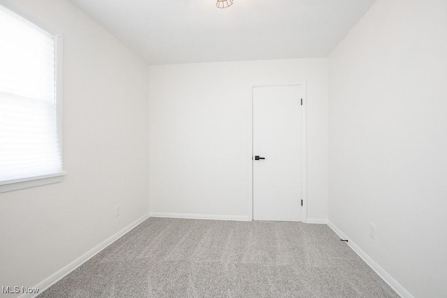 spare room with carpet and baseboards
