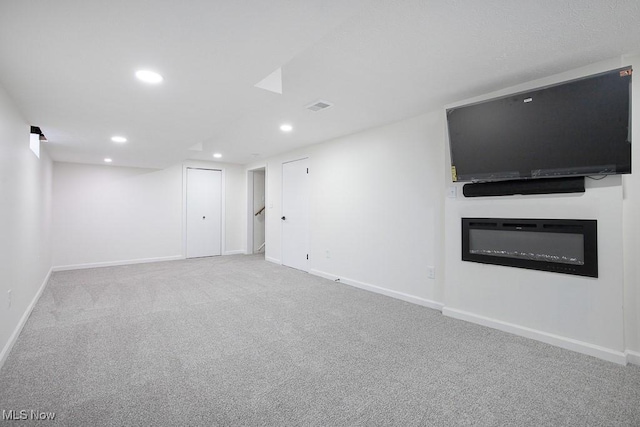 interior space featuring carpet flooring, baseboards, visible vents, and recessed lighting