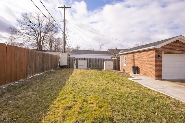 view of yard featuring fence and a garage