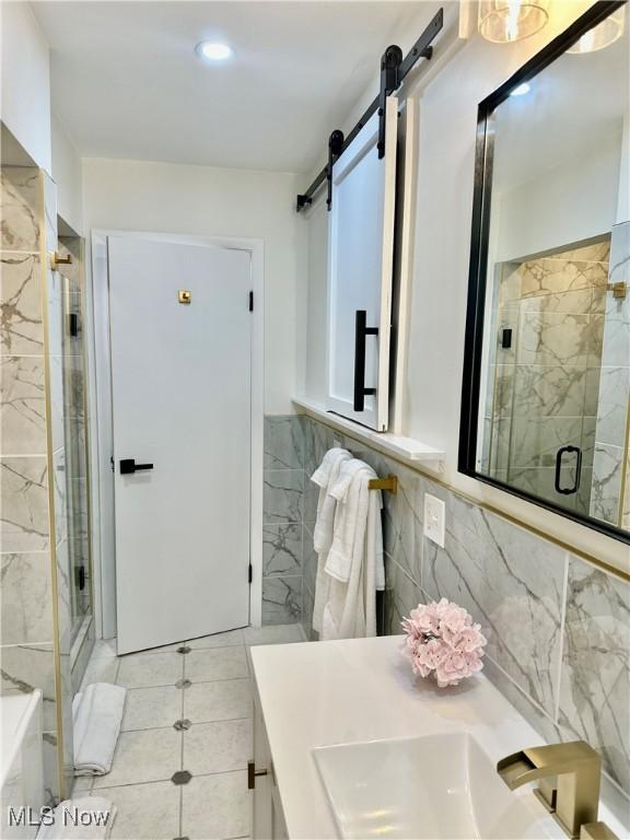 15304 Bartlett Ave, Cleveland, OH 44120 - bathroom with tile walls, a stall shower, vanity, tile patterned flooring, and recessed lighting