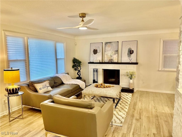 15304 Bartlett Ave, Cleveland, OH 44120 - living room with a fireplace, ceiling fan, wood finished floors, and baseboards