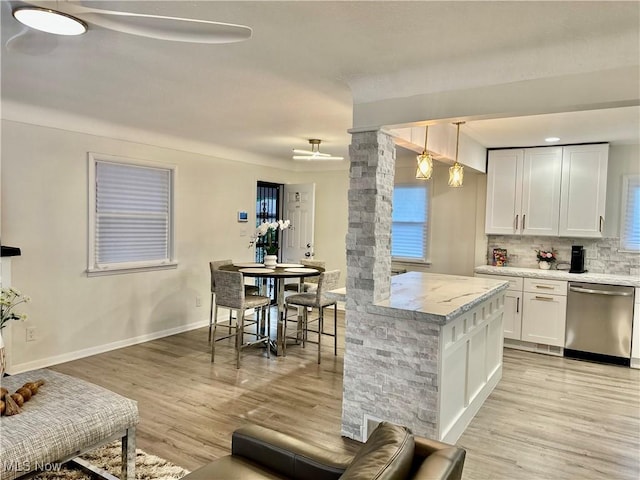 15304 Bartlett Ave, Cleveland, OH 44120 - kitchen with dishwasher, light wood-style flooring, white cabinetry, decorative backsplash, and baseboards