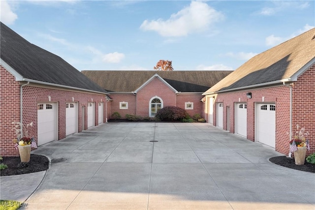2142 State St NW, Uniontown, OH 44685 - view of front of home with concrete driveway, roof with shingles, and brick siding