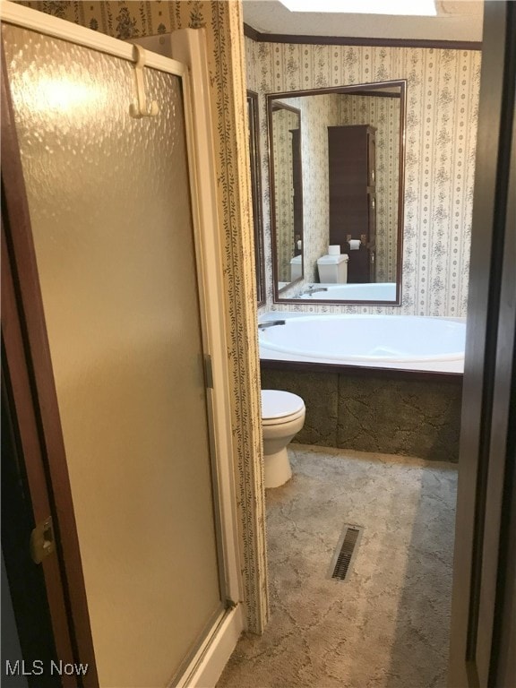 full bathroom with toilet, wallpapered walls, a shower stall, and visible vents