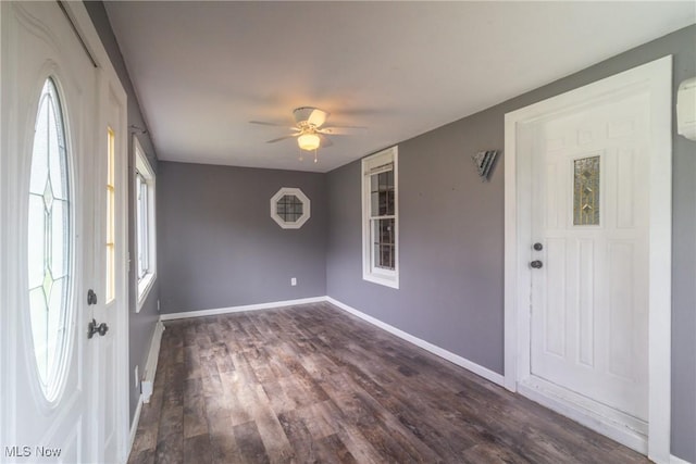foyer featuring baseboards, a ceiling fan, and dark wood-style floors
