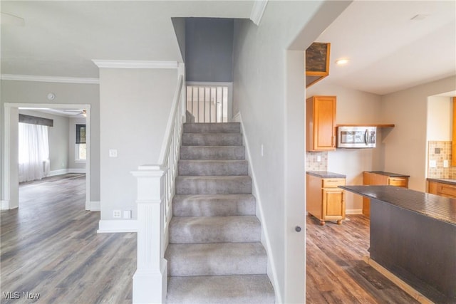 stairs with ornamental molding, baseboards, recessed lighting, and wood finished floors