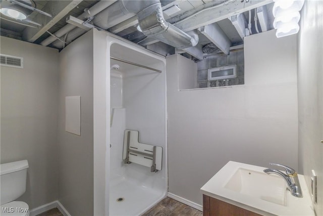 full bath featuring vanity, visible vents, toilet, a stall shower, and baseboards