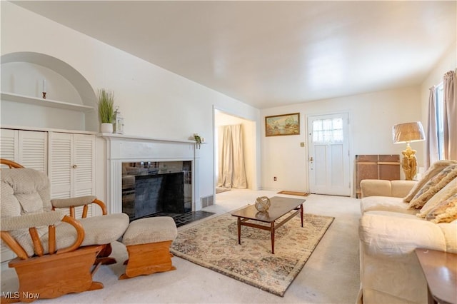 carpeted living room with a fireplace