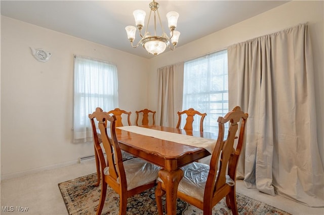 dining area featuring carpet flooring, baseboards, a chandelier, and a wealth of natural light