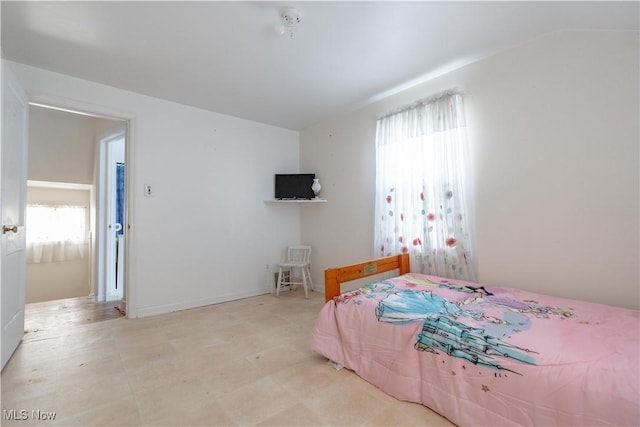 bedroom featuring lofted ceiling