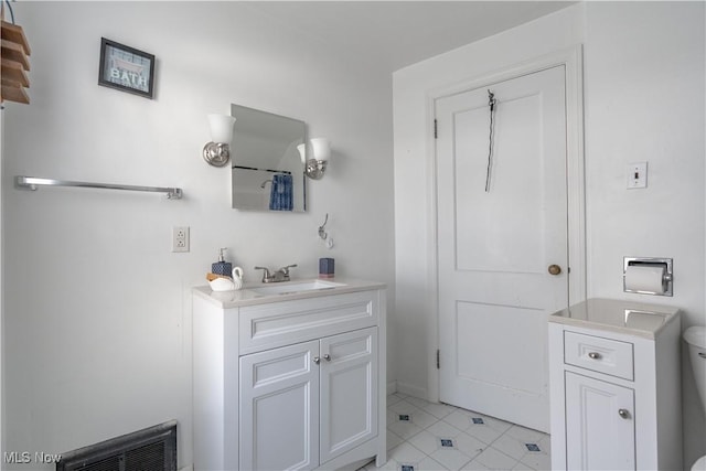 bathroom featuring vanity, tile patterned flooring, toilet, and visible vents