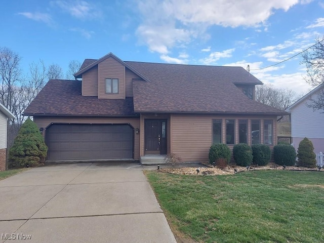 view of front facade with roof with shingles, driveway, an attached garage, and a front lawn