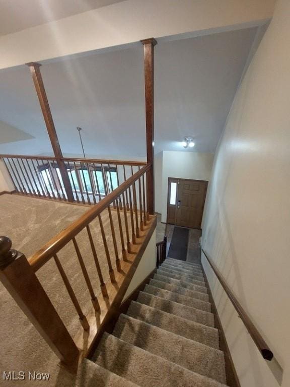 stairway featuring carpet flooring