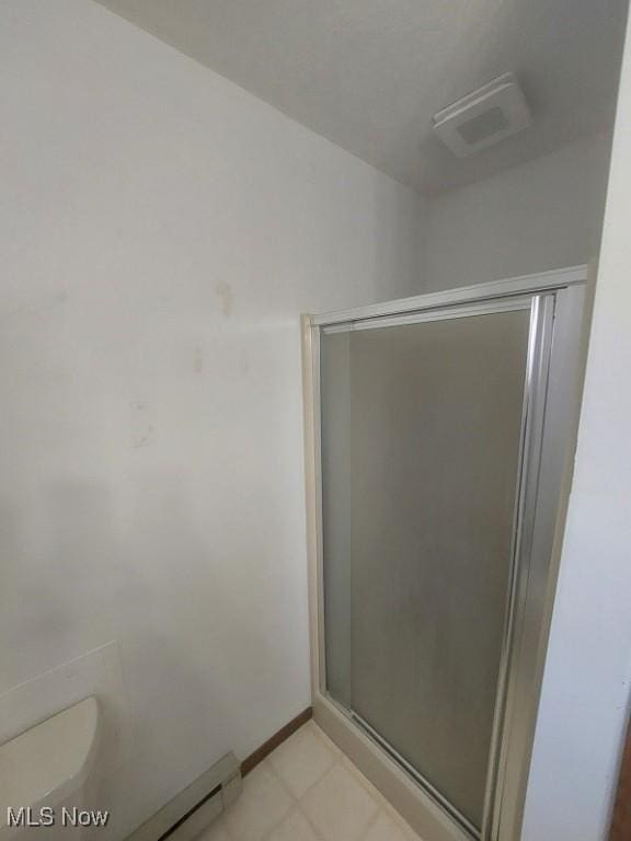 full bathroom with a shower stall, visible vents, baseboards, and toilet
