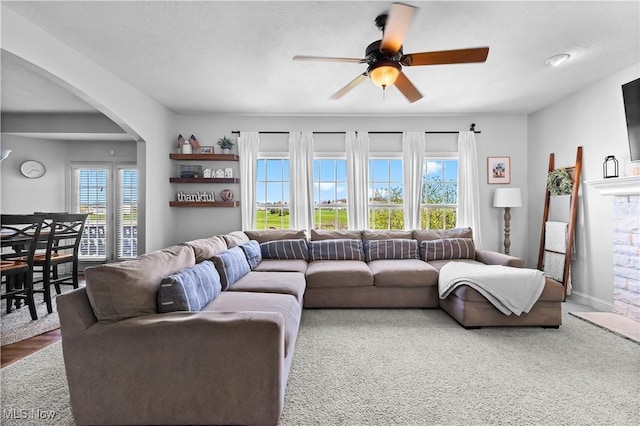 218 Canterbury Ct, Columbiana, OH 44408 - living room featuring ceiling fan, arched walkways, and baseboards