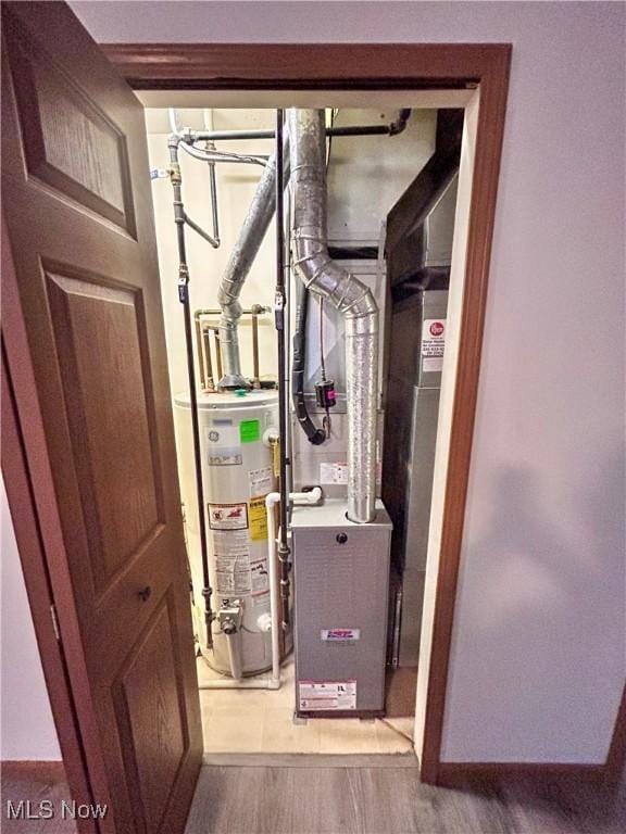 utility room with gas water heater