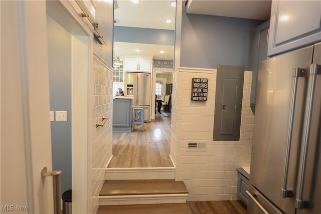 128 Center St, Milan, OH 44846 - bathroom with tile walls, visible vents, and wood finished floors