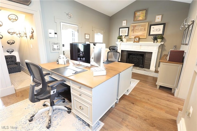 128 Center St, Milan, OH 44846 - home office featuring a high end fireplace, lofted ceiling, and light wood finished floors