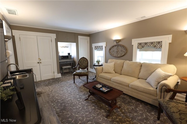 128 Center St, Milan, OH 44846 - living room with crown molding, visible vents, and dark colored carpet