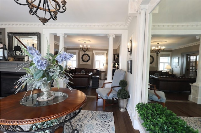 128 Center St, Milan, OH 44846 - interior space with ornate columns, wood finished floors, and an inviting chandelier