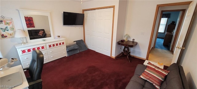 office area featuring baseboards and dark carpet