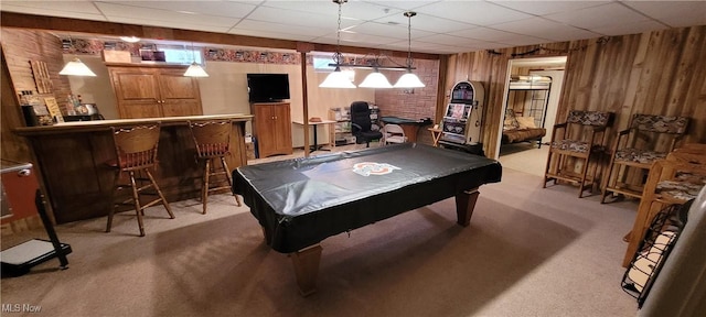 rec room with a paneled ceiling, billiards, light carpet, wooden walls, and a dry bar